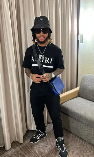 Poco Lee’s Outfit in Amiri T-Shirt, Louis Vuitton Eyewear & Prada Hat (2023)
