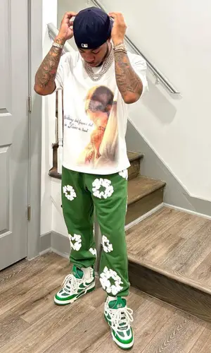 Chino Braxton wearing Denim Tears pants