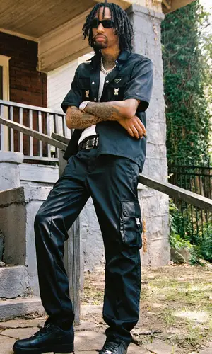 Sonny Digital wearing Prada shirt