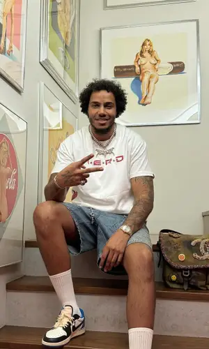 AJ Tracey’s Outfit in Bape T-Shirt, Louis Vuitton Shorts & Chanel Bag (2023)