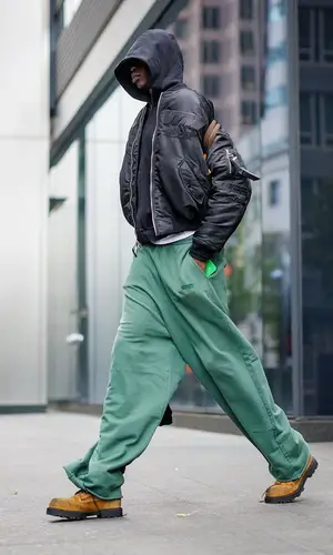 Bol Bol wearing Louis Vuitton backpack