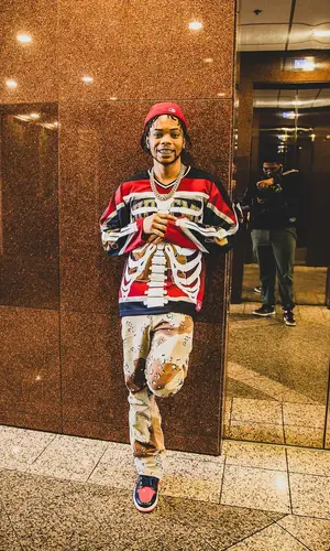 Lil Migo wearing Supreme jersey