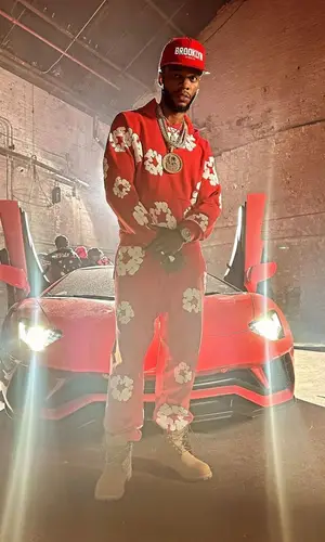 Papoose wearing Denim Tears pants
