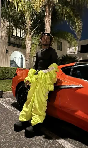 Asake wearing Balenciaga boots