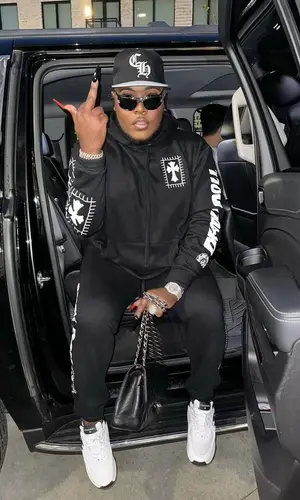 Saucy Santana’s Outfit in Deadly Doll Pants, Chanel Sneakers & Chrome Hearts Cap (2023)
