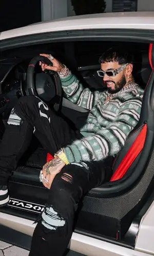 Anuel AA wearing Amiri jeans