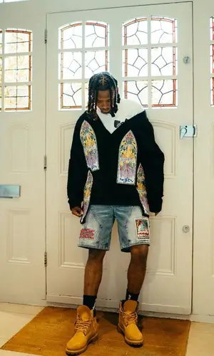 Yhemolee wearing Who Decides War sweater