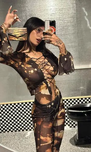 Mia Khalifa’s Outfit in Knwls Top & Amina Muaddi Bag (2023)
