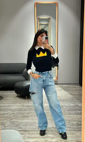 Mia Khalifa’s Outfit in Alice+Olivia Sweater, Maison Margiela Jeans & Miu Miu Boots (2023)