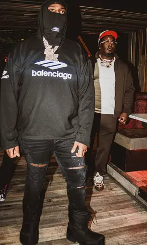 Peezy wearing Balenciaga boots