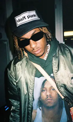 Rich The Kid wearing Louis Vuitton bag
