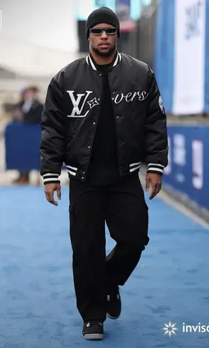 Saquon Barkley’s Outfit in Eminem Merch Sneakers, Louis Vuitton Eyewear & Carhartt (2024)