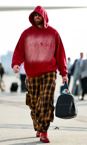Travis Kelce’s Outfit in Marni Hoodie, Collina Strada Trousers & Nike Sneakers (2024)