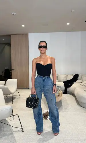 Kim Kardashian’s Outfit in Carhartt Jeans, Hermes Bag & Balenciaga Eyewear (2024)
