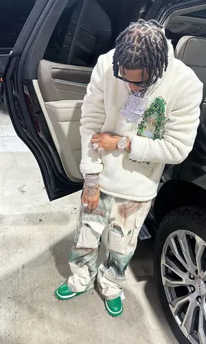 Lil Migo wearing Who Decides War trousers