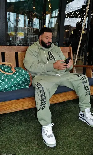 DJ Khaled wearing Louis Vuitton bag