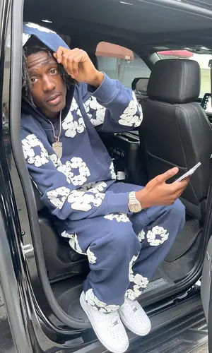 DracBaby wearing Denim Tears pants