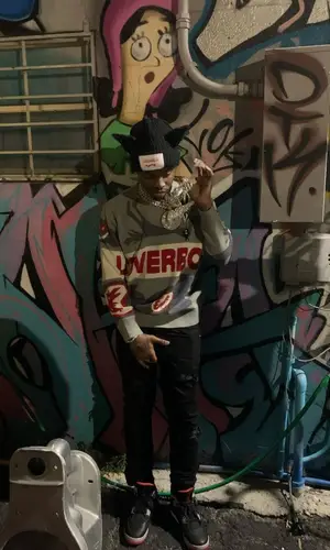 Lil Double 0’s Outfit in Amiri Jeans, Jordan Sneakers & Loverboy by Charles Jeffrey Hat (2024)