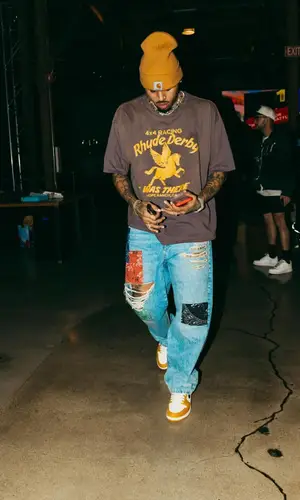 Chris Brown’s Outfit in Rhude T-Shirt, Alanui Jeans & Carhartt Hat (2024)
