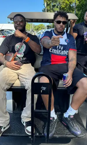 AJ Tracey’s Outfit in Nike T-Shirt, Prada Eyewear & Paris Saint-Germain (2024)
