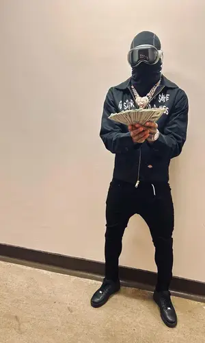NLE Choppa wearing Nike hat