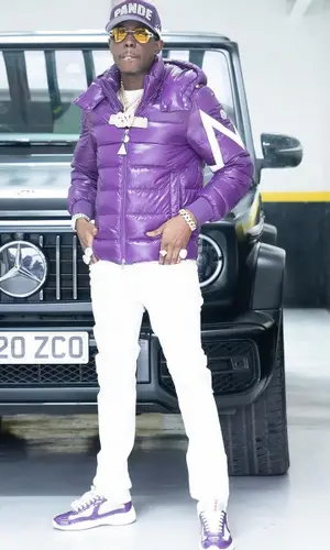 Bobby Shmurda’s Outfit in Moncler Jacket, Prada Sneakers & Pandemonium Clothing Club Cap (2024)