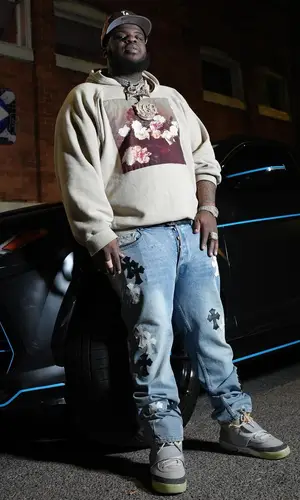 Maxo Kream’s Outfit in Raf Simons Hoodie, Chrome Hearts Jeans & Jon Stan Cap (2024)