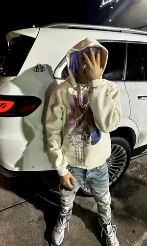 Stunna Gambino’s Outfit in Meek Mill Merch Hoodie, Amiri Jeans & Asics Sneakers (2024)