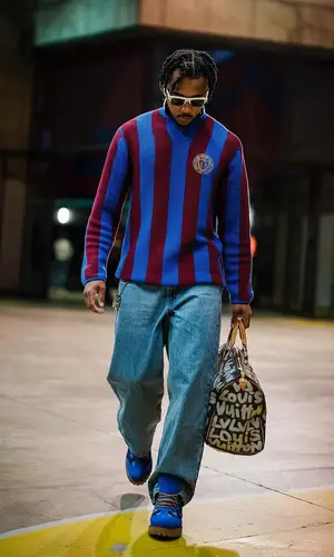 Jules Kounde’s Outfit in Aime Leon Dore Jersey, Louis Vuitton Bag & Kenzo Eyewear (2024)