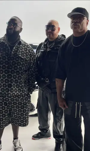 Rick Ross wearing Honor The Gift shirt