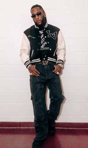Burna Boy wearing Louis Vuitton jacket