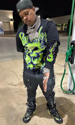 Finesse2tymes wearing Balenciaga sneakers