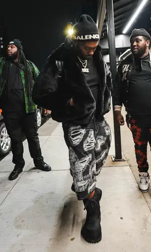 Peezy wearing Bottega Veneta backpack