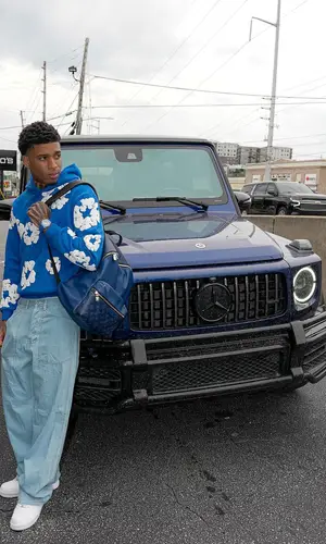NLE Choppa wearing Louis Vuitton backpack