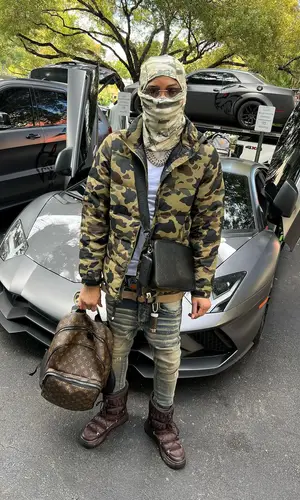 Lil Migo wearing Louis Vuitton bag