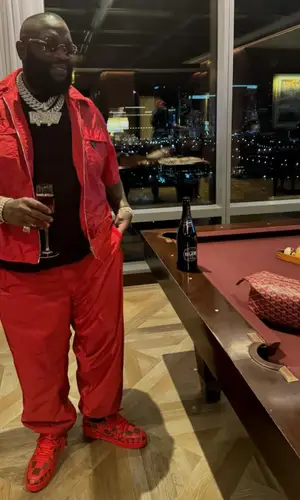 Rick Ross’ Outfit in Prada Shirt, Louis Vuitton Sneakers & Goyard Bag (2024)