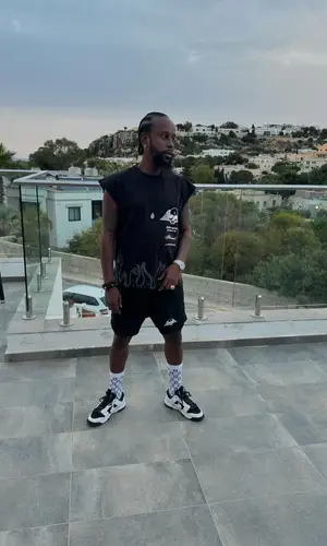 Popcaan’s Outfit in Civil Regime Shorts & Nike Sneakers (2024)