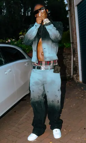 Masicka wearing Louis Vuitton jeans