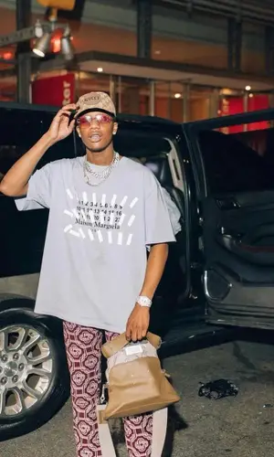 Smooky MarGielaa wearing Maison Margiela bag