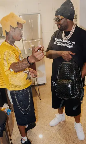 Peezy wearing Bottega Veneta backpack
