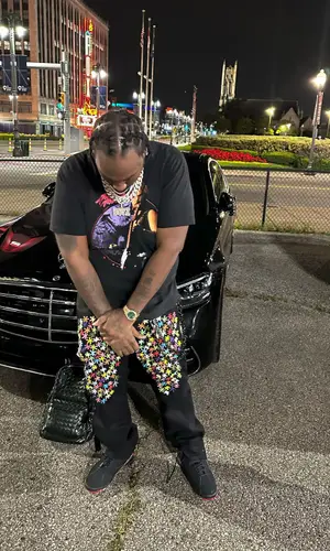 Peezy wearing Bottega Veneta backpack