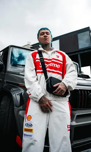 Blessd’s Outfit in Supreme Jacket, Burberry Bag & Ducati Corse (2024)