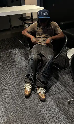 UnoTheActivist wearing Louis Vuitton sneakers