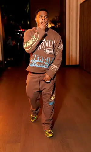Fridayy wearing Honor The Gift sweater