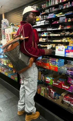 Meek Mill’s Outfit in Celine Hoodie, Amiri Pants & Goyard Backpack (2024)