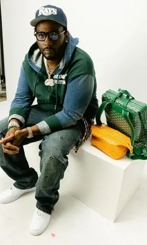 Peezy wearing Goyard backpack