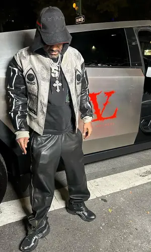 Jim Jones wearing Who Decides War hoody