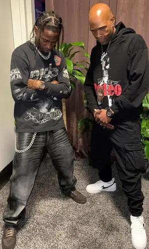 Travis Scott wearing Travis Scott Merch top
