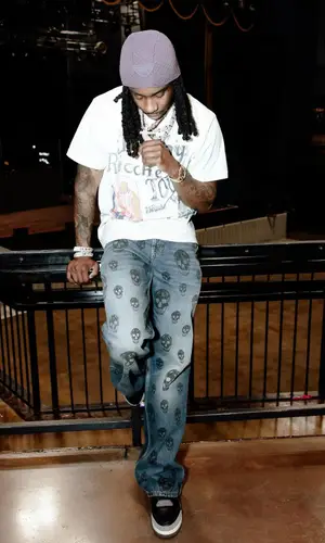 Polo G’s Outfit in Alexander McQueen Jeans, Jordan Sneakers & Prada Hat (2024)