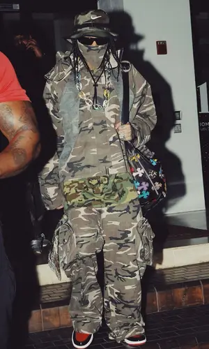 Tyga’s Outfit in Fffpostalservice Jacket, Chrome Hearts Eyewear & Nike Hat (2024)